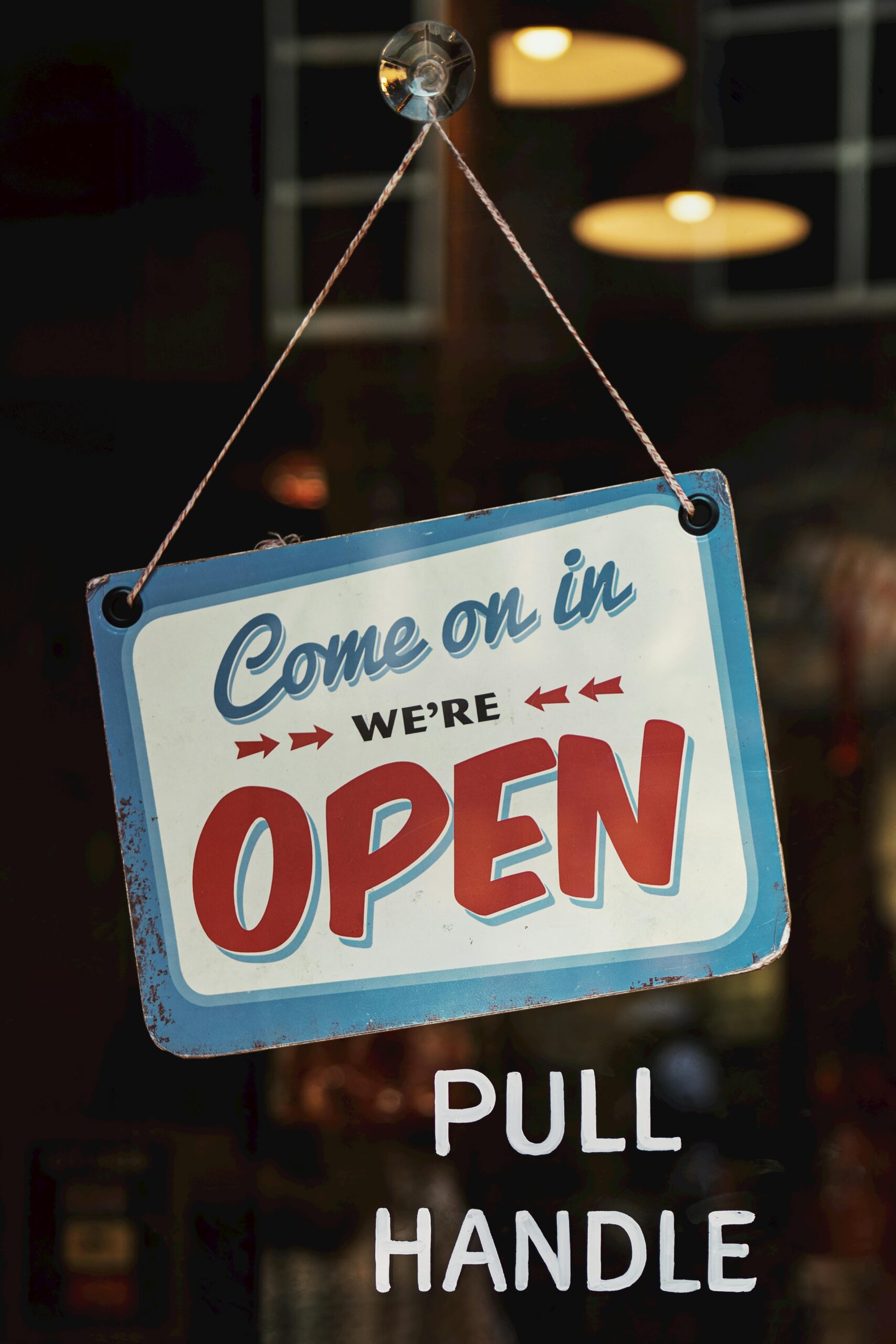 Vintage-style open sign welcoming customers into a Nashville shop. Perfect for illustrating business atmosphere.